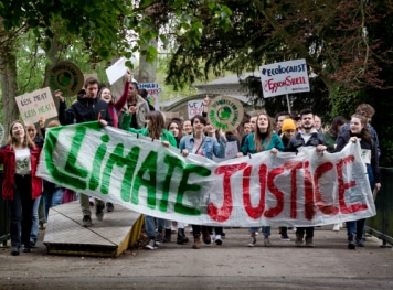 A group of people holding protest about Climate Justice.