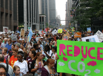 Crowd of protesters in the middle of the city with regards to reducing CO2.