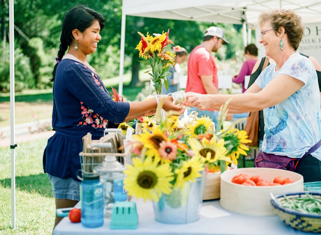 Eva Moss (left) sells flowers at a farmers market in North Carolina.