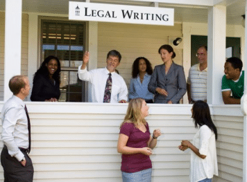 A group of people having a conversation outside the legal writing section.