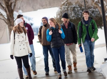 A group of students walking outside on a snowy day.