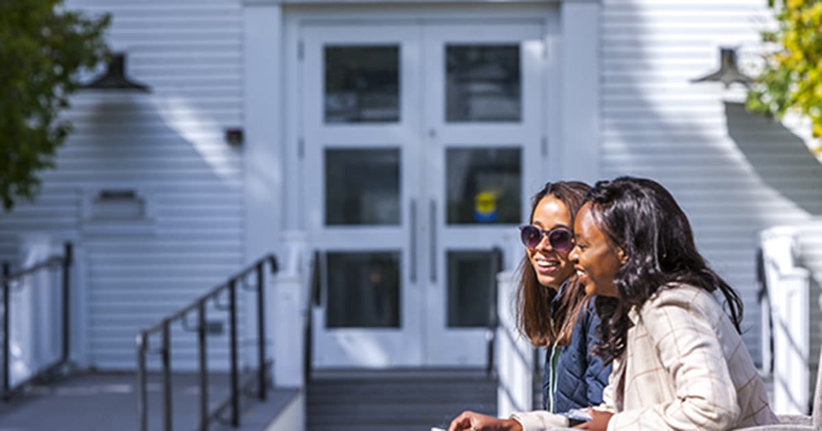 Two VLGS students in front of the Cornell Library