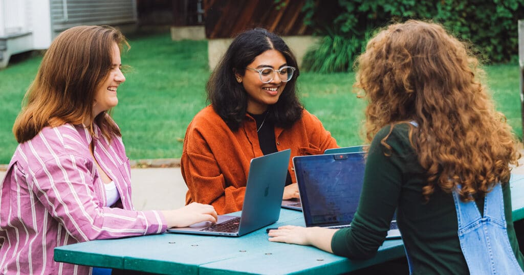 Three Students Studying Together on the VLGS Library Quad